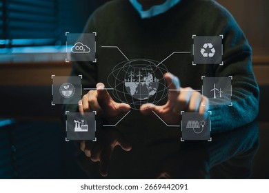 Man using futuristic interface with smart tech and mobile to manage ESG, clean energy, and sustainability data. in office