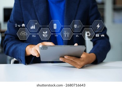 Man using futuristic interface with smart tech and mobile to manage ESG, clean energy, and sustainability data.