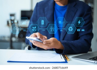 Man using futuristic interface with smart tech and mobile to manage ESG, clean energy, and sustainability data.