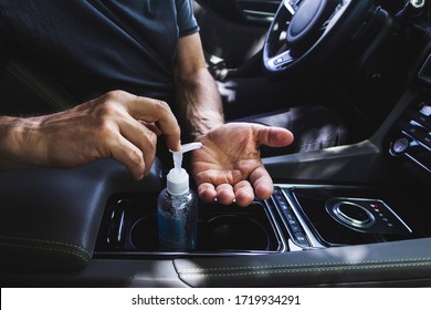Man using hand sanitizer in the car. Man sitting in the car disinfect his hands to avoid coronavirus infection. Close-up on hands. - Shutterstock ID 1719934291