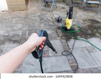 Man Using A High Pressure Syringe To Clean Tiles. Can Also Be Used To Remove Weeds Between Tiles.