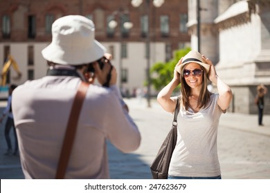Man using his camera to take a picture of his girlfriend