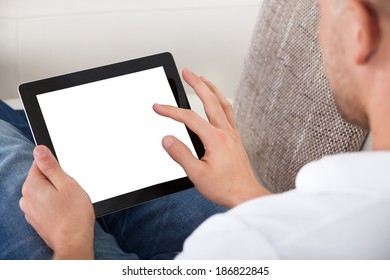 Man Using His Fingers To Navigate On A Tablet-pc  Over The Shoulder View Of The Blank Touchscreen