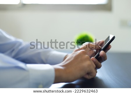 a man using his smartphone and touching clicking the screen