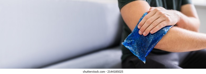 Man Using Ice Gel Pack On Injured Arm