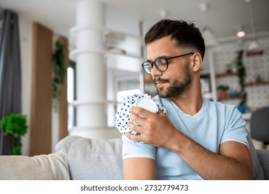 Man Using Ice Pack for Shoulder Pain Relief, Joint Injury Treatment Concept. Male Feeling Muscle Ache and Applying Cold Compress at Home. Healthcare and Medicine Concept of Orthopedic Problem.