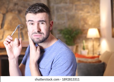 Man Using Industrial Pliers To Remove Tooth