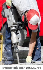 Man Using Jackhammer On Pavement. Construction Worker Repairing Concrete Pathway With Jack Hammer - Santiago, Chile