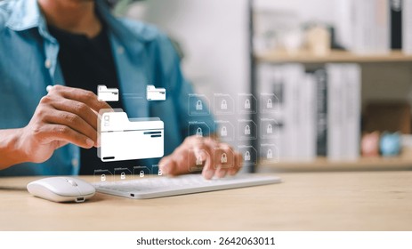 Man using keyboard to manage digital file folders with secure lock icons. Concept of data security, cloud storage, file encryption, and digital document protection.