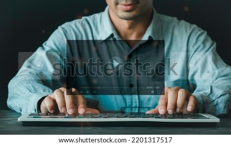 Man using the keyboard for streaming online on virtual screen, watching video on the internet, live concert, show or tutorial, content online. on the internet concept