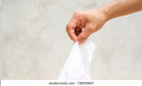 Man Using A Kleenex On Gray Background.