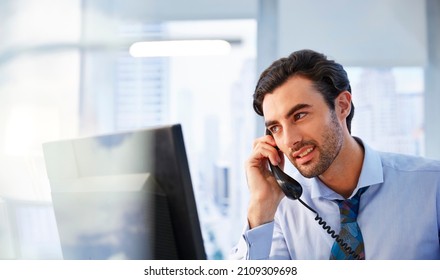 Man Using Landline Phone In Office