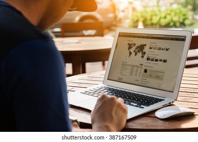 Man Using Lap Top On Wooden Table