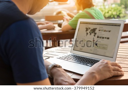 Man using lap top on wooden table