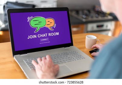 Man Using A Laptop With Chat Room Concept On The Screen