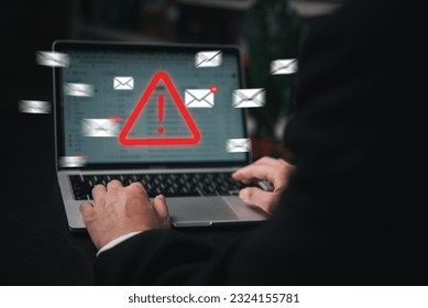 Man using laptop computer with hacker alarm protecting data from cybercrime in the digital age. Internet security and privacy defending against data theft and email breach.