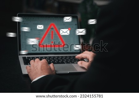 Man using laptop computer with hacker alarm protecting data from cybercrime in the digital age. Internet security and privacy defending against data theft and email breach.
