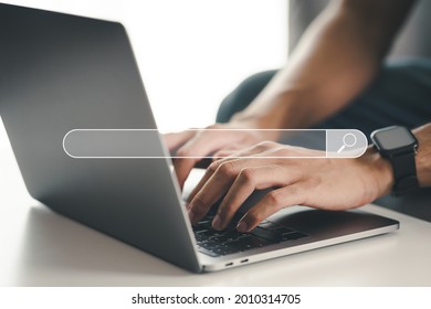 Man using a laptop computer to Searching for information with the Search bar, Web browser, Data Search, Search Engine, Technology Concept