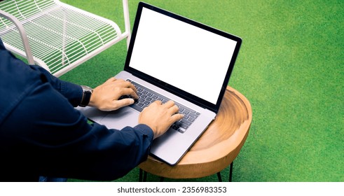 Man using laptop computer showing blank screen white backgbround notebook at home for copy space or advertising text.