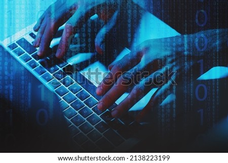 A man Using a laptop computer under blue light, one and zero digits on foreground layer.