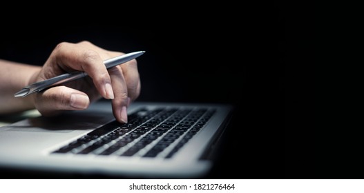 Man Using Laptop Or Computer Working At Home In The At Night For Web Banner With Copy Space. 