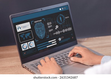 Man using a laptop to create convincing fake image, video and audio recording. Deepfake and artificial intelligence concept.