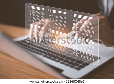 Man using laptop to do online survey online exam Choosing the right answer in the exam, filling out an online survey form. Answer the test questions.