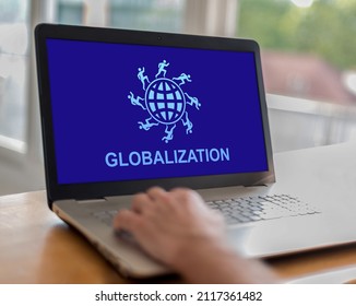 Man using a laptop with globalization concept on the screen