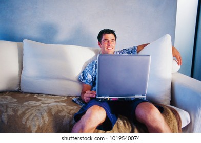 Man using laptop on couch