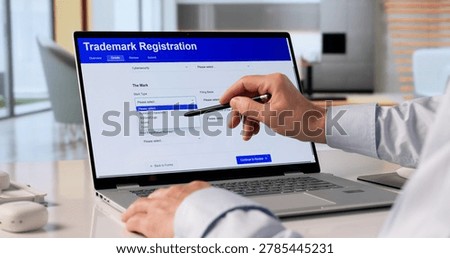 Man Using Laptop To Submit Trademark Application For Business Brand Protection.