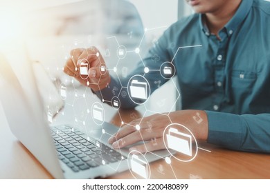 Man using laptop and touching on internet cloud document storage technology icon virtual screen with document management system, icons on virtual screens.technology innovation concept. - Shutterstock ID 2200480899