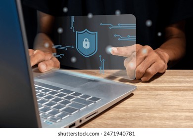 Man using a laptop with virtual screen of cyber security technology for protecting personal data and secure internet access concept.