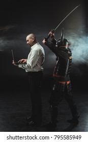 Man Using Laptop While Samurai Making Hit With Sword