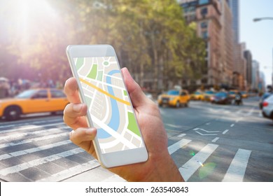 Man using map app on phone against new york street