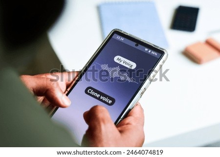 Man using mobile applications for cloning his voice. Selective focus, cyber scam concept.