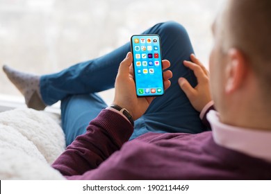 Man using mobile phone at home - Shutterstock ID 1902114469