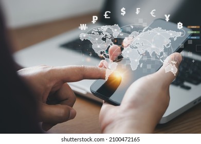 Man using mobile phone and laptop computer to money transfers and currency exchanges between countries of the world. online banking interbank payment concept. - Shutterstock ID 2100472165