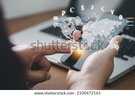 Man using mobile phone and laptop computer to money transfers and currency exchanges between countries of the world. online banking interbank payment concept.