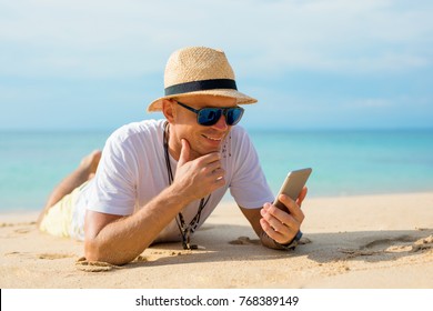 Man using mobile phone on the beach - Powered by Shutterstock