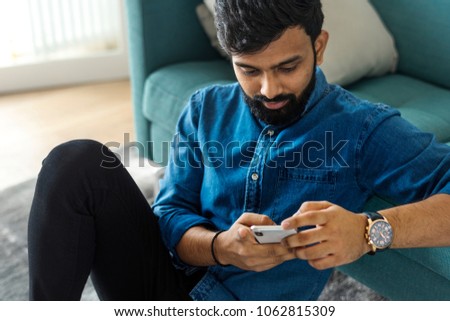 Man using mobile phone on the floor