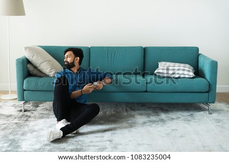 Man using mobile phone on the floor alone