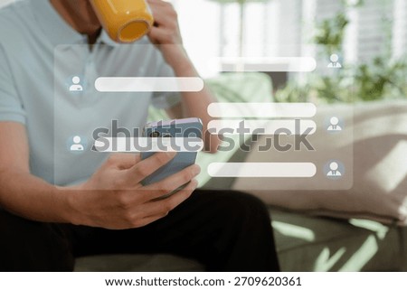 Man are using a mobile phone playing social media and laptop wifi connection sitting on sofa, home office workplace lifestyle people.	