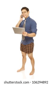 Man Using A Mobile Phone And Tablet Computer While Wearing Boxer Shorts With Shirt/tie (isolated On White)