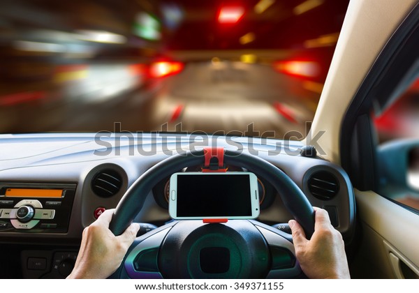 Man using a\
mobile phone while driving in\
night.