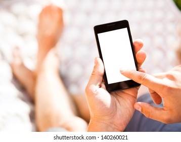 Man using mobile smart phone while relaxing in a hammock - Powered by Shutterstock