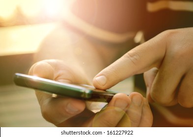 Man using mobile smart phone outdoor - Powered by Shutterstock