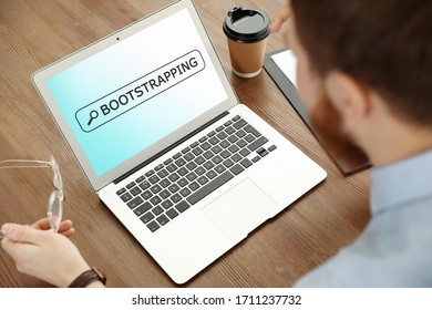 Man Using Modern Laptop At Table, Closeup. Bootstrap Button