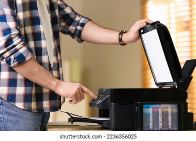 Man using modern multifunction printer in office, closeup