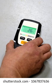 Man Using Moisture Meter For House Inspection. 