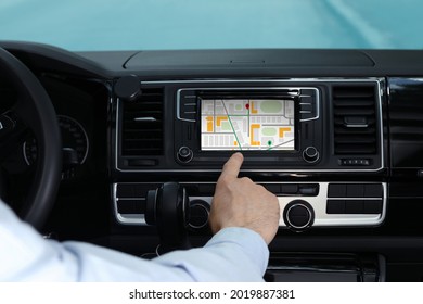 Man using navigation system while driving car, closeup